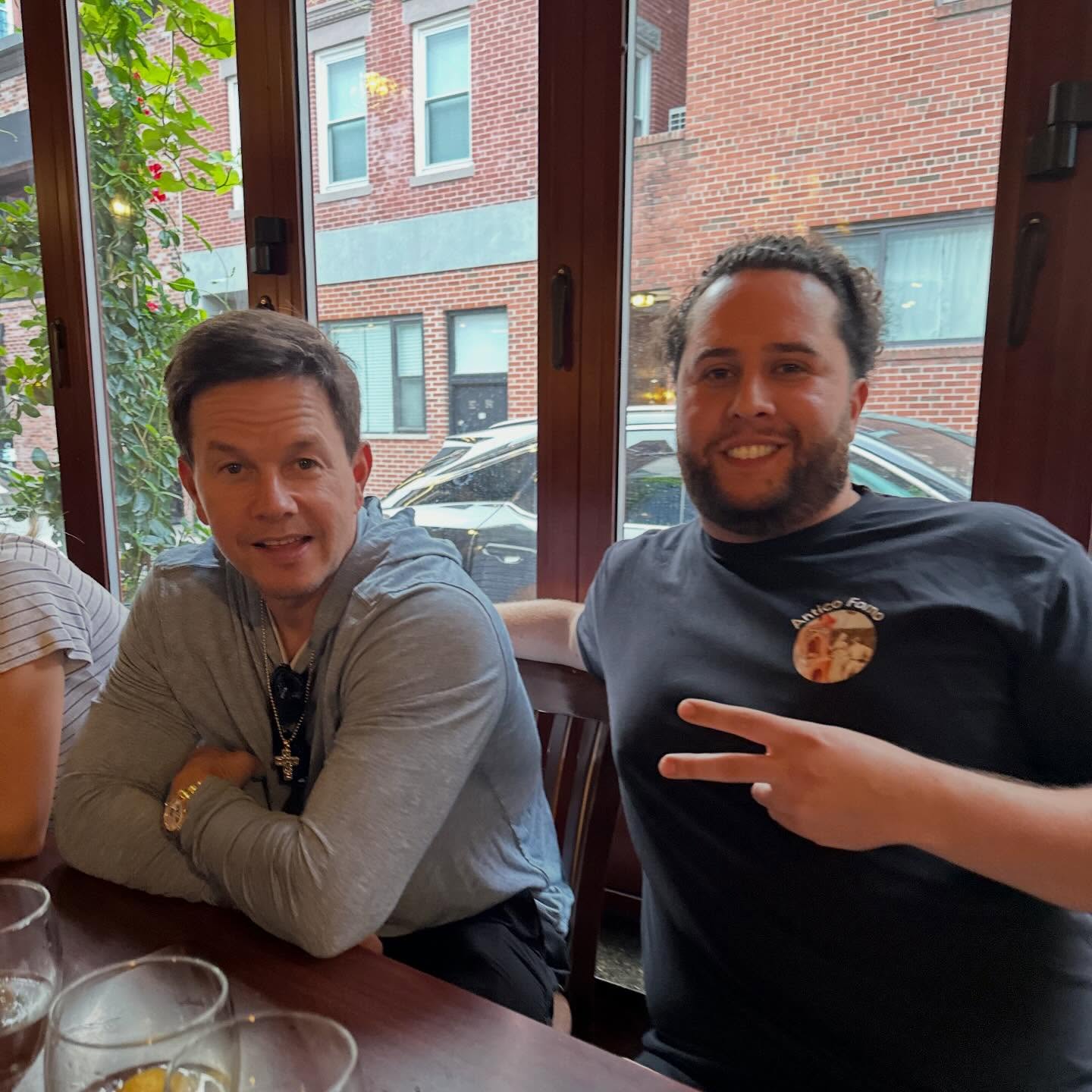 C-Money and Mark Wahlberg at a restaurant.